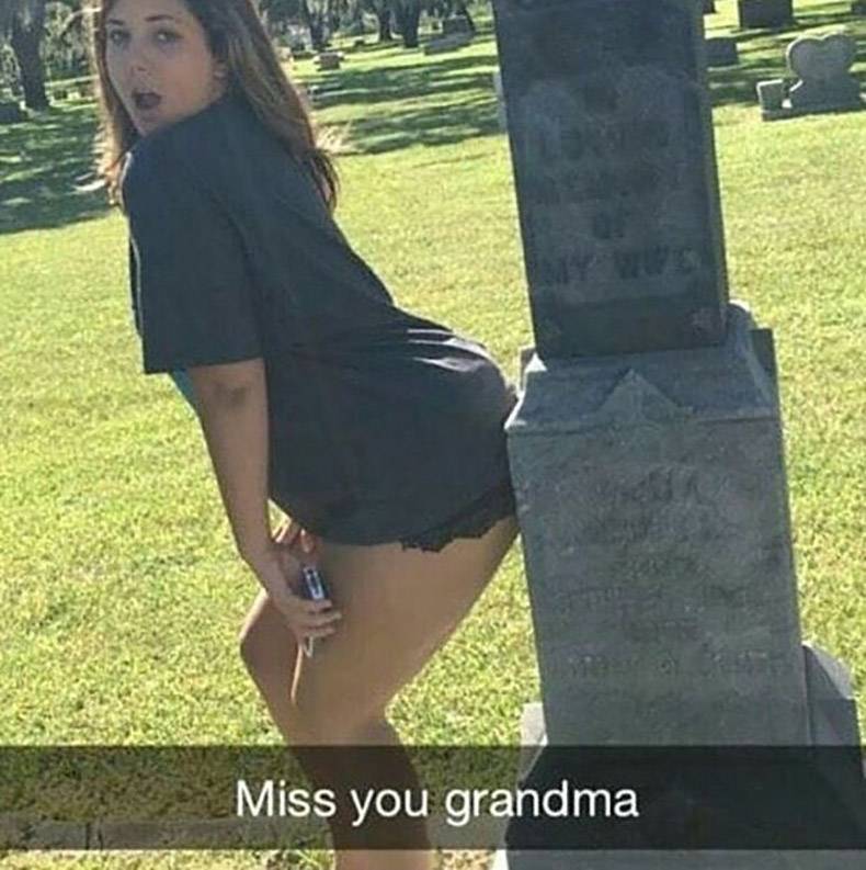 Woman dancing provocatively against a grave stone in snapchat captioned 'Miss Your Grandma'