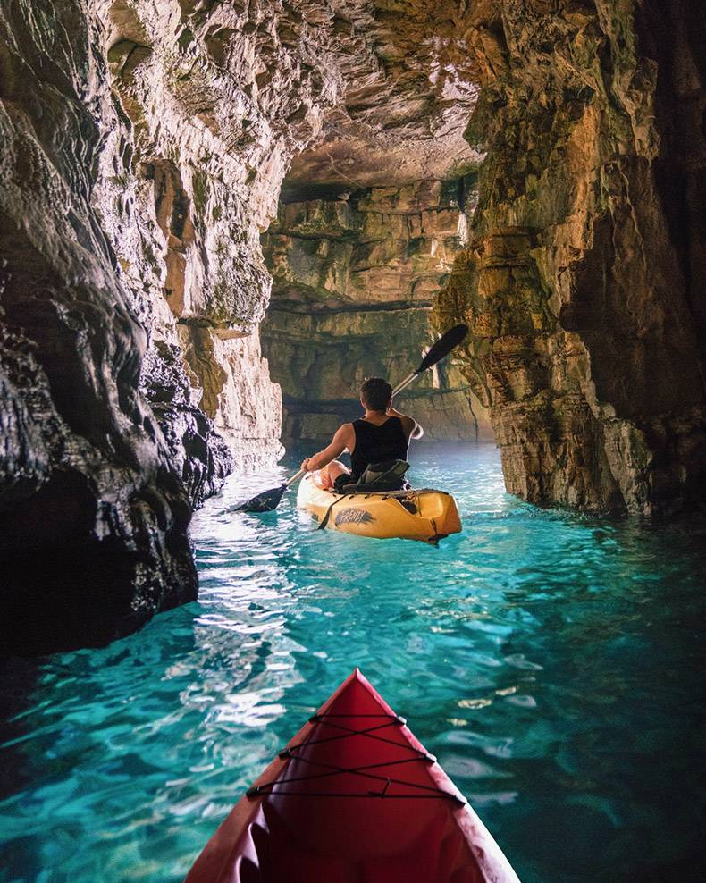 Awesome pic of kayaking through a cave.