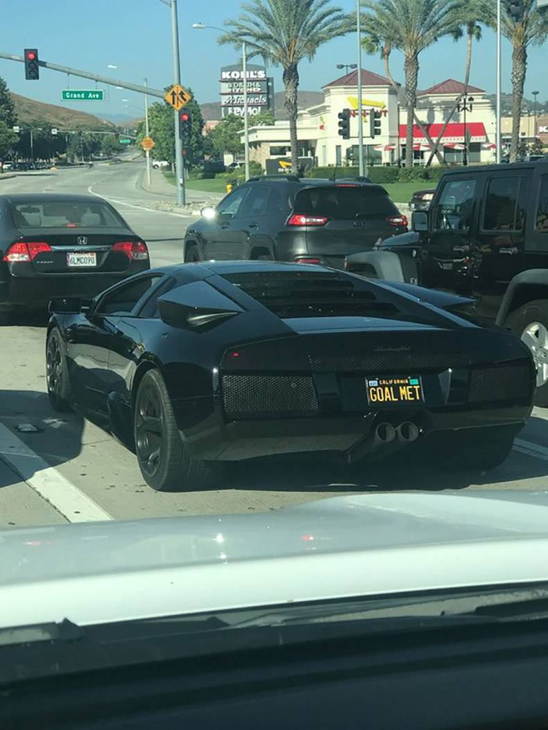 Black Lamborghini with license plate that says GOAL MET