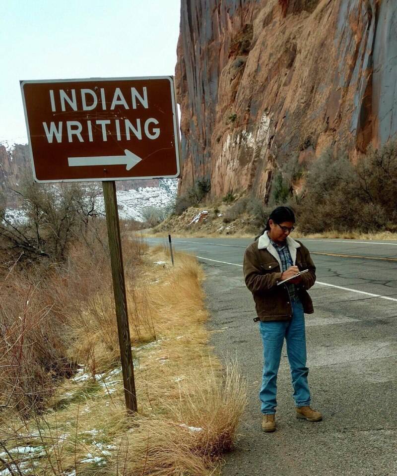 Sign to the Indian writing with picture of Indian man writing