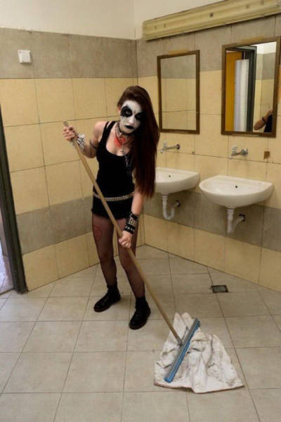 girl with facepaint washing the floor