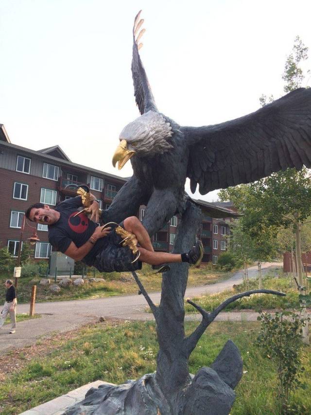 eagle statue man posing as capture
