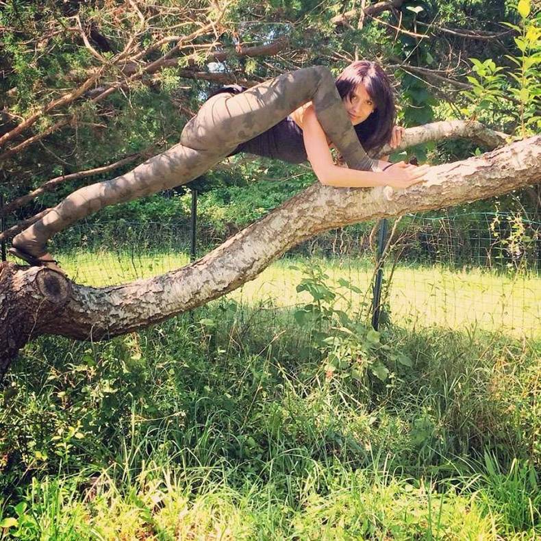 girl stretching on a tree