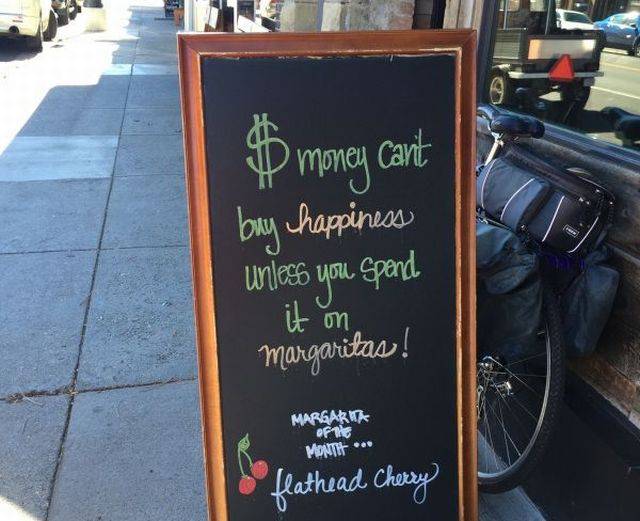 signage - $ money cant buy happiness unless you spend it on Margaritas! Margarita of the Montir ... & flathead Cherry