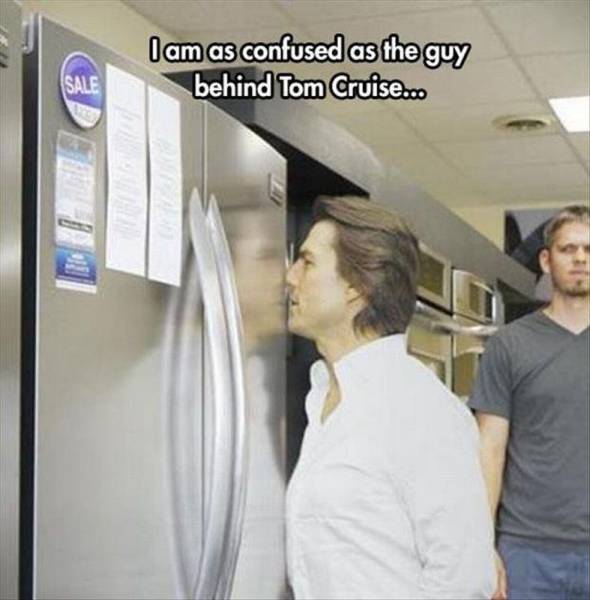 tom cruise smelling refrigerator - I am as confused as the guy behind Tom Cruise....