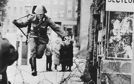 1961, Hans Conrad Schumann jumping into West Berlin (by Peter Leibing). Capturing the moment of a soldier escaping from the communist Eastern Bloc by leaping over the barbed wire, this picture summed up the desperation of the Cold War.