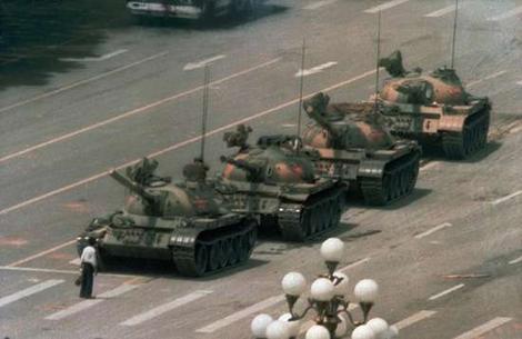 1989, Tiananmen Square protest (by Jeff Widener). The government sent tanks to brutally kill hundreds of workers, students and children in a crackdown on the protest at Tiananmen Square. A small, unknown, unexceptional figure stood bravely in protest in front of the tanks. It is when history becomes allegory that the camera writes it best; and as TIME magazine reported it, tank man "revived the world's image of courage."