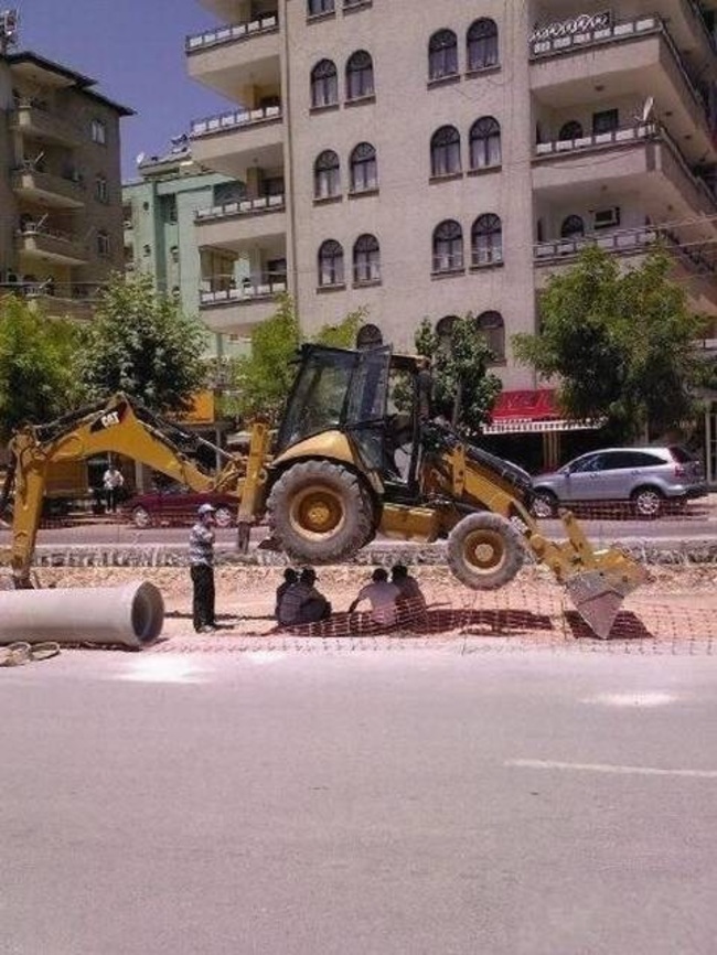 When these guys relaxed in the shade of their backhoe