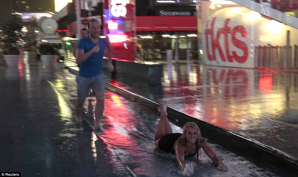 funny picture of couple sliding down the gutter of a street