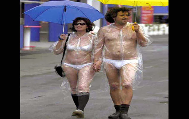 funny picture of couple in the rain wearing underwear and transparent over coats