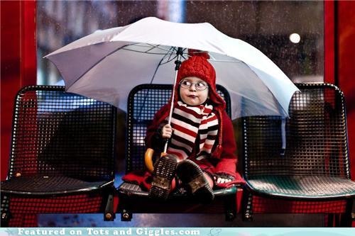 funny picture of kid wating in bus stop in the rain