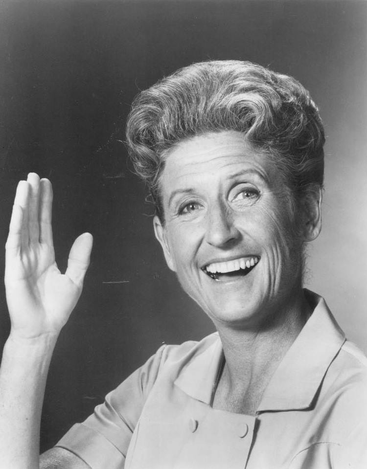 Black and white photo of Ann b Davis waving