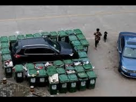 car surrounded by trash cans