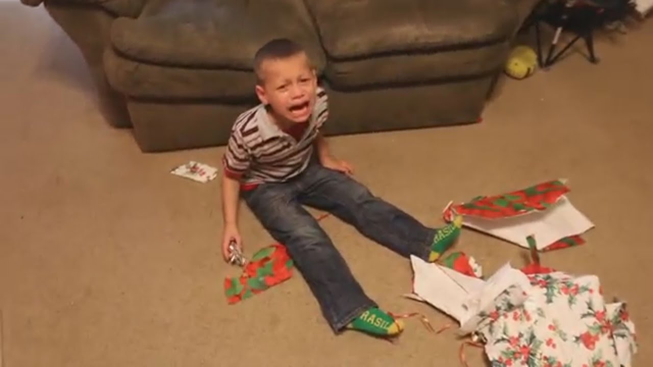 kids crying over a present