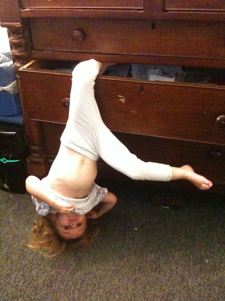 kid hanging from drawer