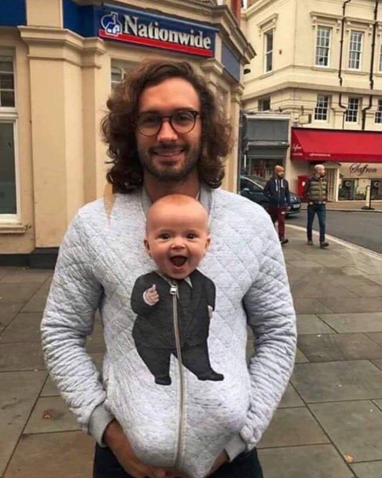 guy wearing hoodie with baby body drawn on it and real baby face popping out