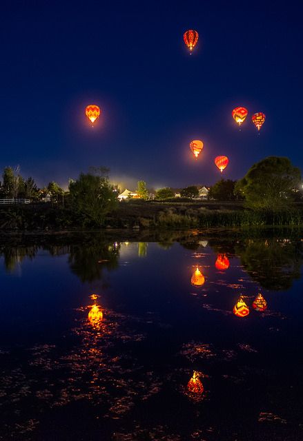 hot air balloons at night in the sky