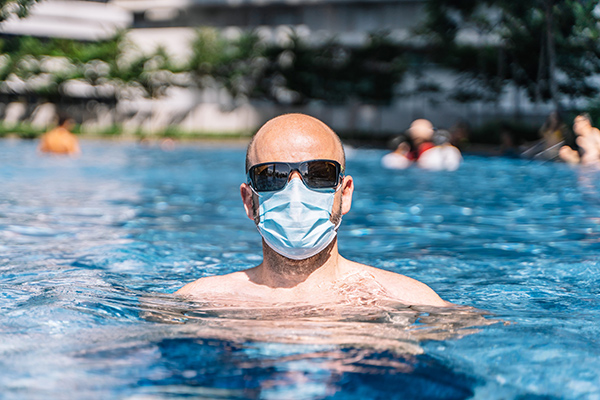guy wearing a face mask in the pool
