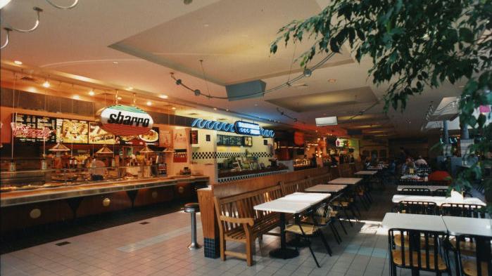You remember the neon lights of food courts