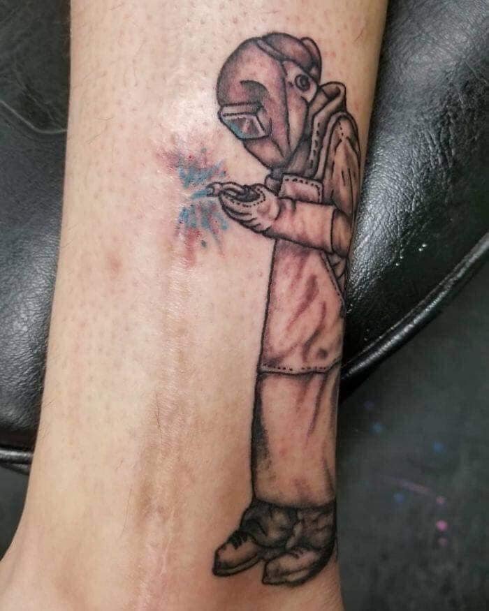 scar leg tattoo
