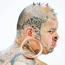 The largest ear lobe hole flesh tunnel. His girlfriend's just holds his earlobe when his hands are full.