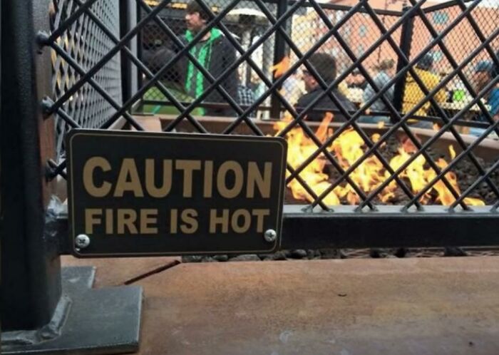 signs you need a new sign - pointless signs - Caution Fire Is Hot