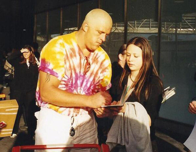 A young Emma getting an autograph from Goldust.