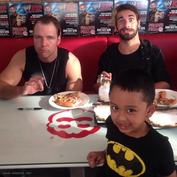 Dean Ambrose and Seth Rollins taking a pic with this little Batman fan. Notice they were trying to eat, yet Seth looks like he doesn’t fully mind. Dean thoughâ€¦