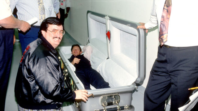 This creeps me out for some reason. Paul Bearer standing outside the casket that was made for the Undertaker / Warrior match, with Vince McMahon just lazying around inside of it.