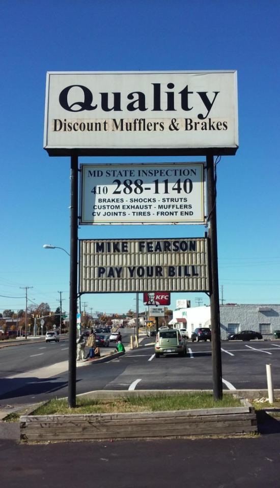 Funny picture of a place that sells car services and has the name of delinquent client on their sign.
