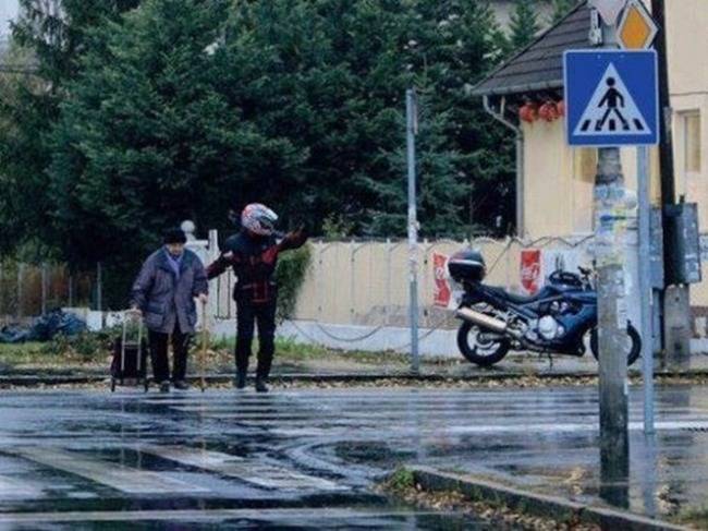 This biker who stopped traffic to help a little old lady cross the street