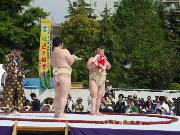 Naki Sumo:
In Japan, two sumo wrestlers stand across from one another holding an infant born the previous year, attempting to make the other’s child cry. If they don’t cry the referee will throw on a scary mask.
