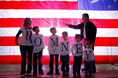 Reality: That isn't actually Romney's family in the photo. Nor was his name misspelled when this scene happened in real life. The misspelling was achieved via photoshop. The original picture was taken by Reuters photographer Brian Snyder at a Romney campaign rally in Elko, Nevada.