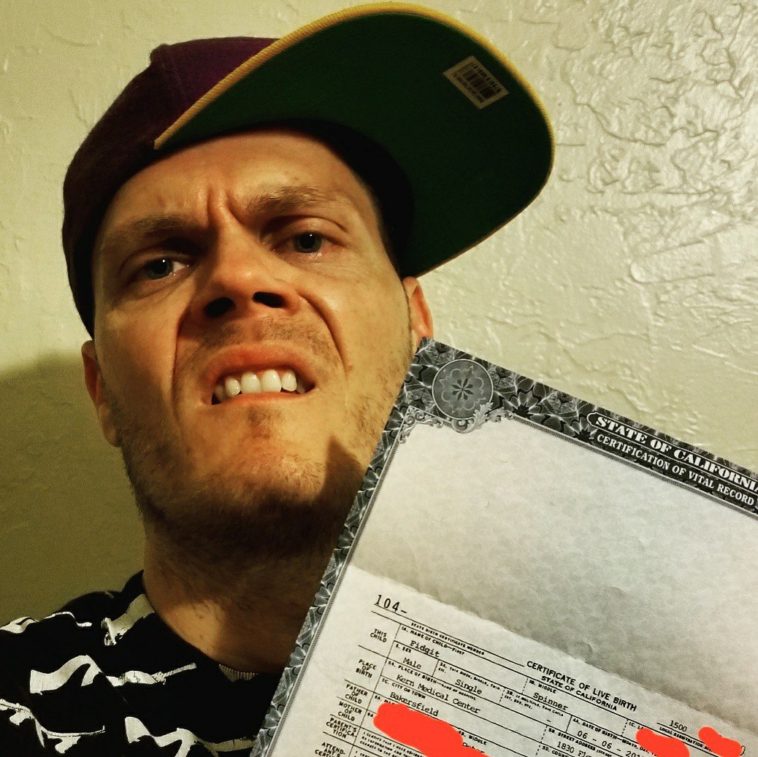 The new father posing with his son's birth certificate. The story goes that "fidget's" mom, this guy's baby mama, let Mr. Bright Ideas, name their child whatever he wanted. Well, the jokes on her I guess! 