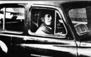 Photo with a faint figure sitting in the back seat which the taker claimed was the ghost of her mother.
