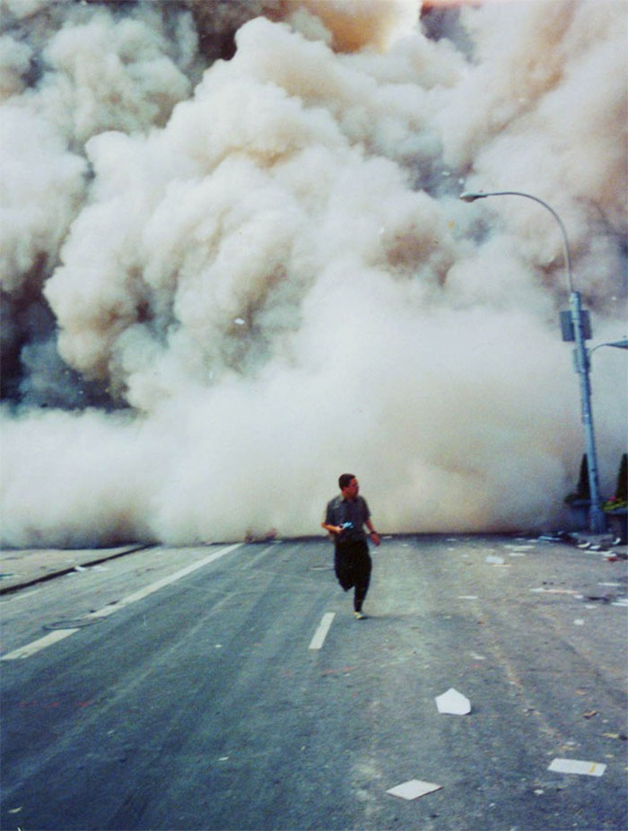 Man running from the falling rubble of the World Trade Center on Sept 11th