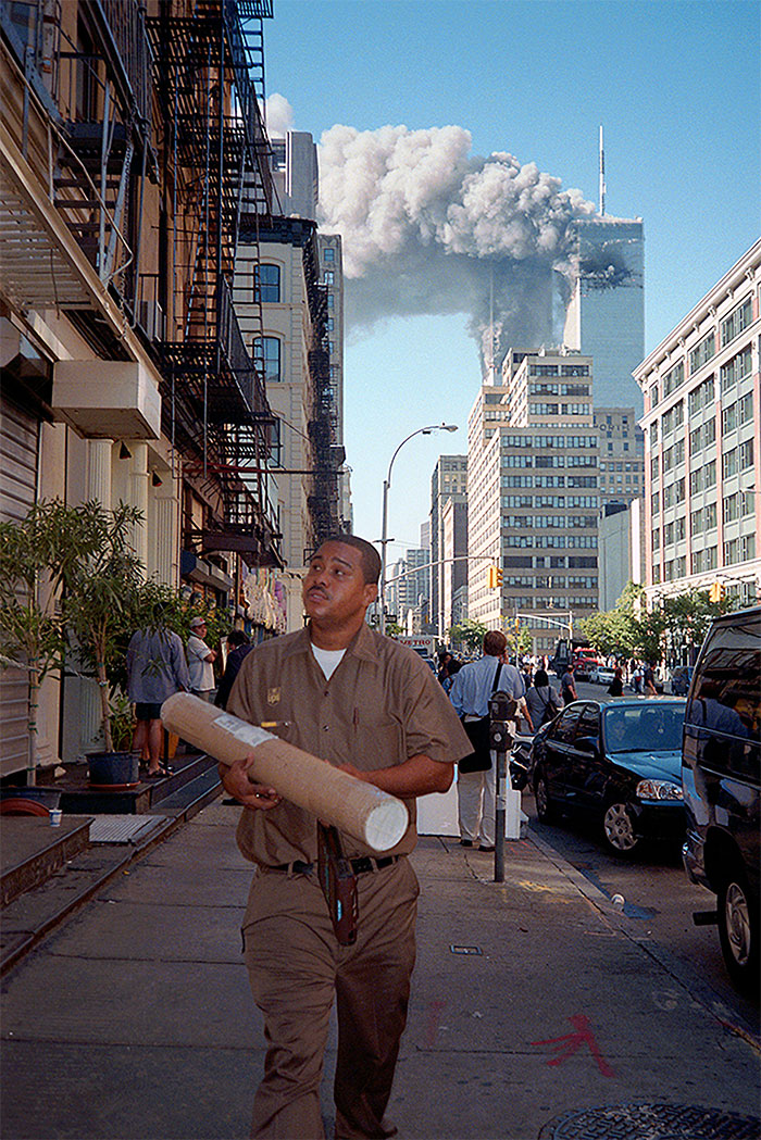 UPS delivery man making a drop as the WTC burns behind him