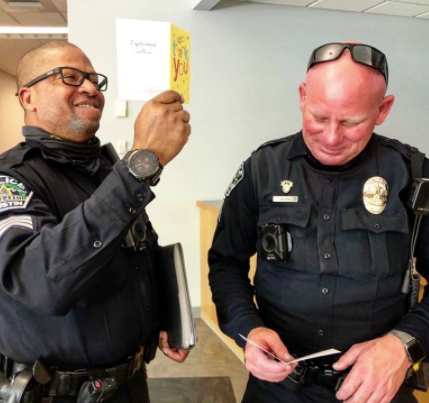 Austin police officers looking a thank you cards