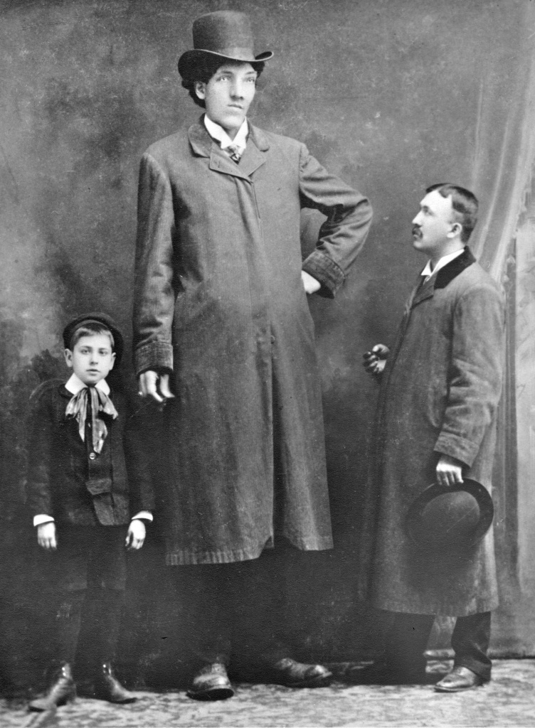 EDOUARD BEAUPRÉ - Unlike most sideshow performers, there is much known about the life of this real life giant. Beaupré was born in the small Saskatchewan of Willow Bunch and was average height until he was nine. At nine years old little Edouard was 6.1 ft. tall and at age eleven he had grown to 7.1 ft. He stopped going to school however he was very intelligent, speaking French, English, Souix, Cree and Méchif. He passed away in St. Louis on July 3, 1904 where his final height had reached 8.3ft, making him one of the tallest humans in recorded history.