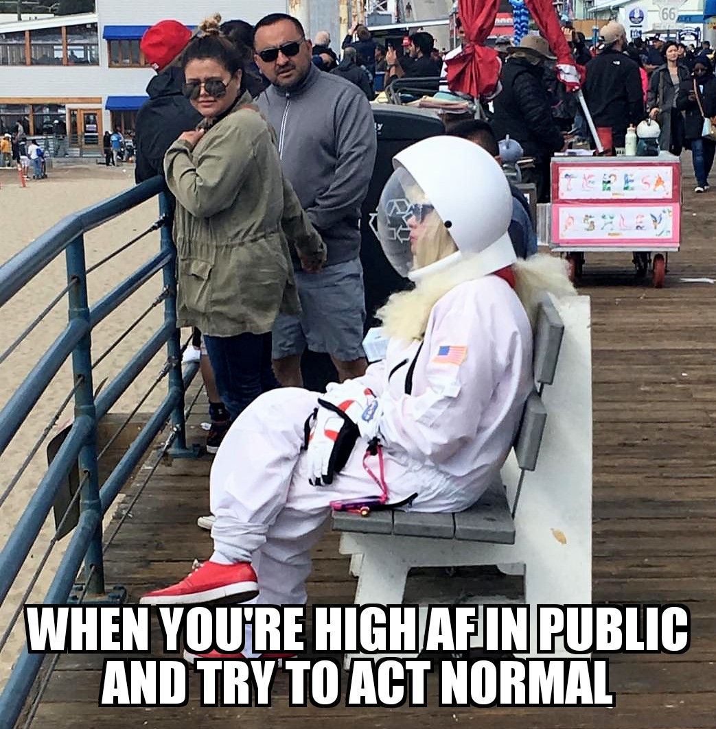 Meme about acting normal when you are high AF in public - Woman sitting on bench wearing space suit.