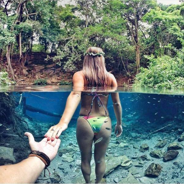Girl leading hand in the water in a bikini