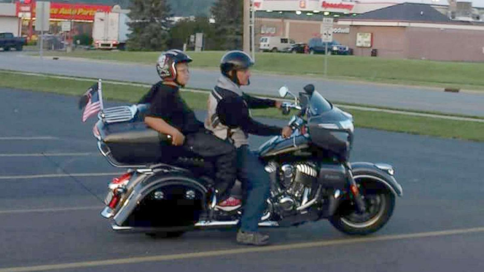 Phil riding on the back of one of the bikers named Brett Warfield on his way to school.