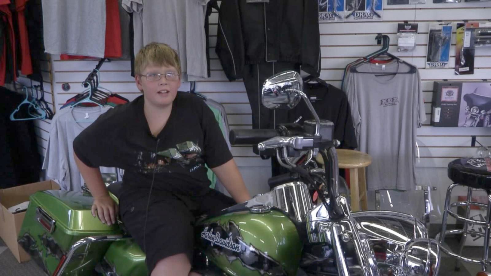 Phil sitting on a green chopper motorcycle.