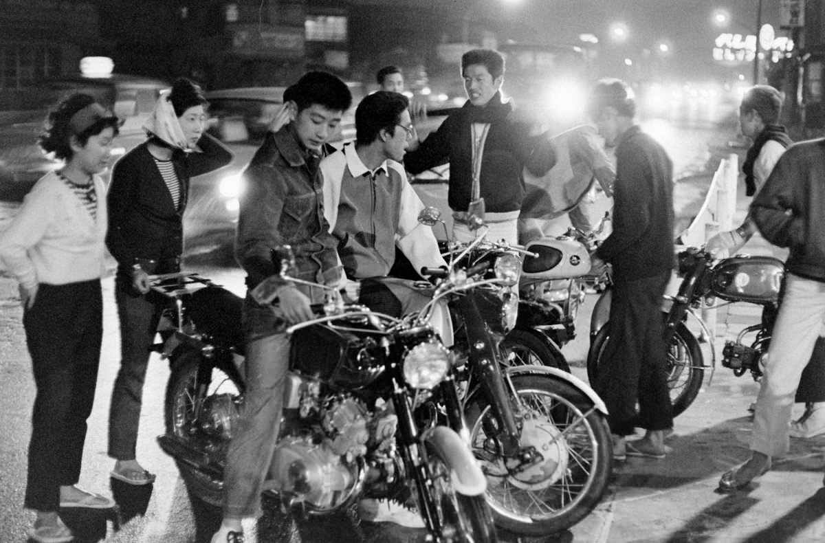A Japanese teenage biker gang and their friends hang out in Tokyo in 1964.