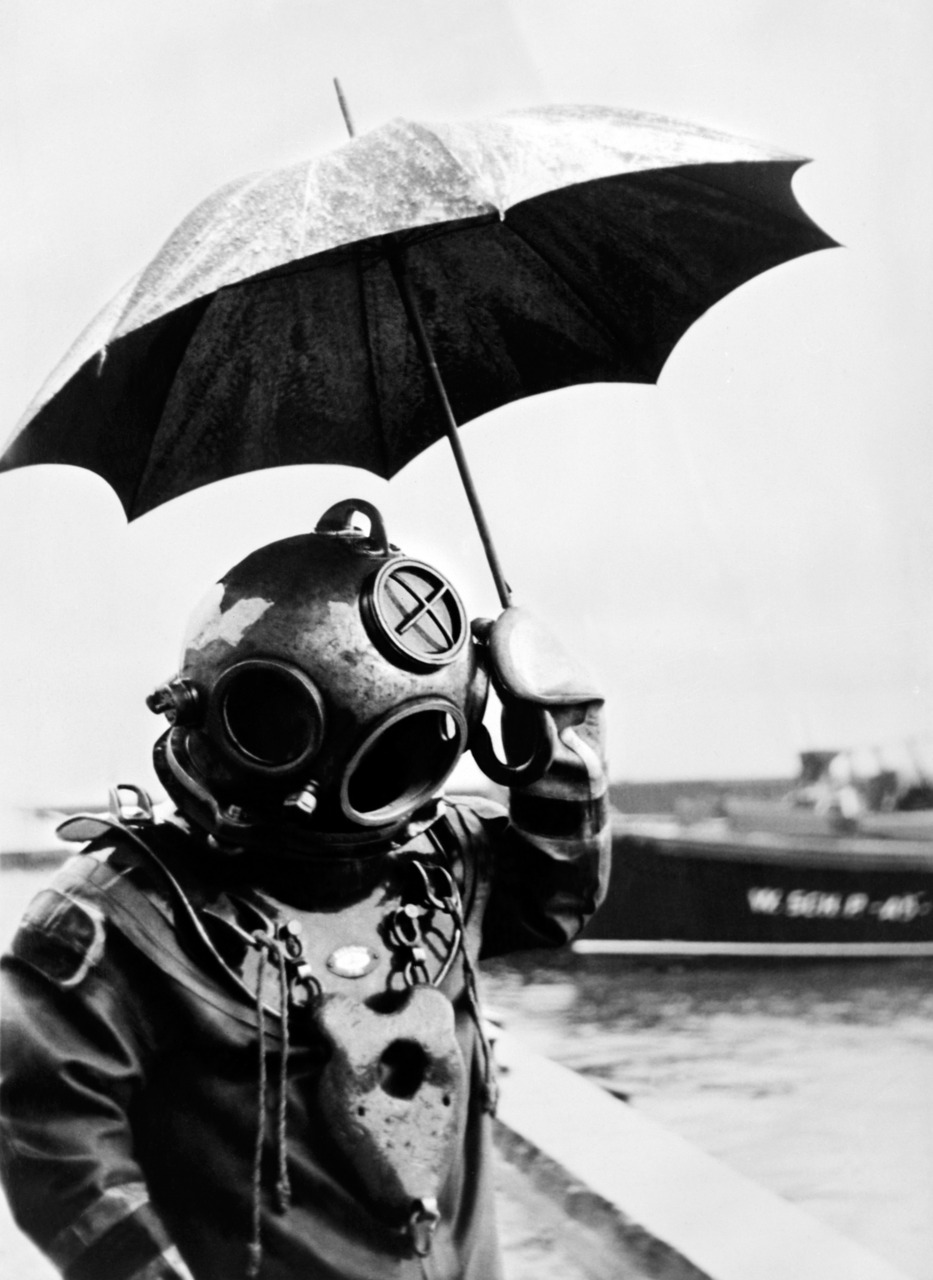 A diver goofs off by holding an umbrella sometime in the mid 1940s.