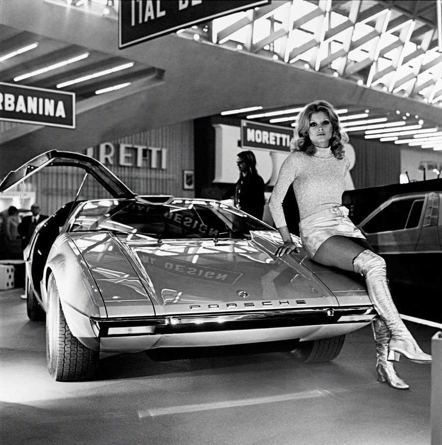 A model sits on a concept car, the Porsche Tapiro, in 1970.
