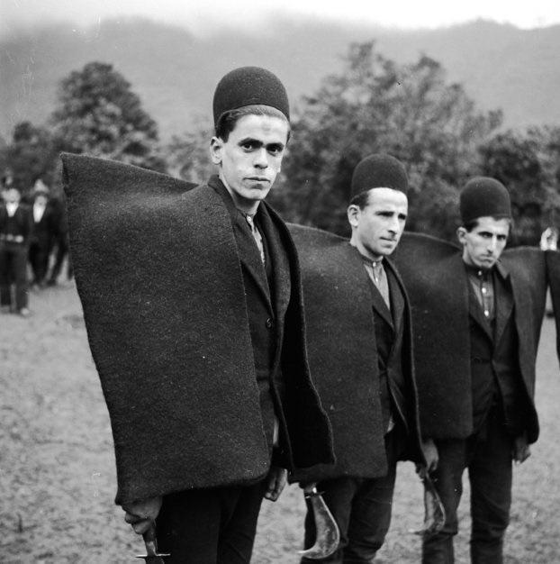 Persian shepherds from Northern Iran wearing their traditional heavy woolen mantles as they get ready to shear sheep in 1952.