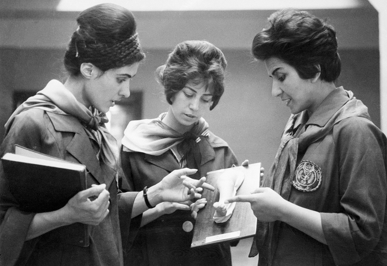 2 Medical students (middle, left) ask questions as their medical professor (right) shows them a plaster cast of part of the human body at the Faculty of Medicine in Kabul, Afghanistan in 1962.