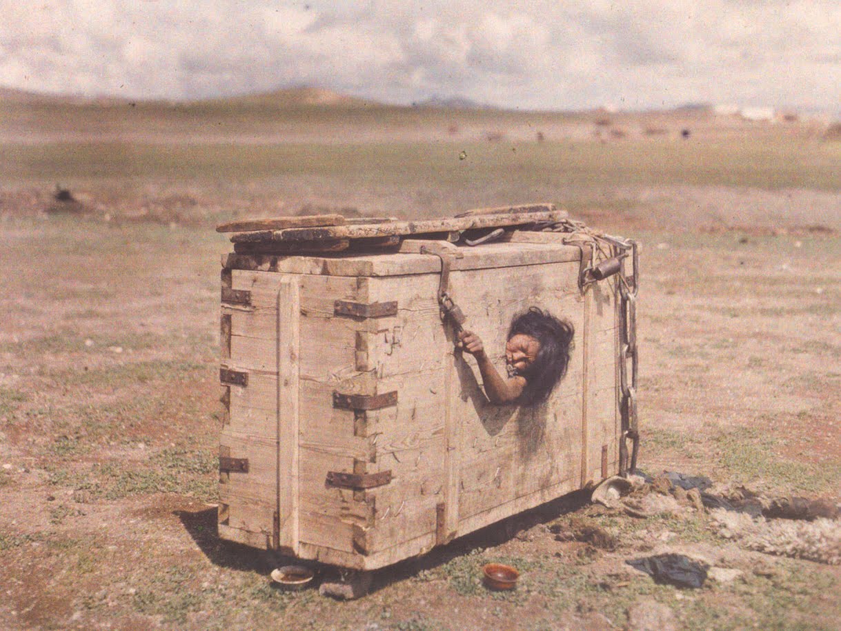 This woman has been put in a sealed box with 1 small hole, no food and no water, for the punishment of adultery in Mongolia in 1913. The sentence is actually death. The hole is part of the design, allowing the condemned to see the freedom they have been denied. This woman, and many like her, died this way and for many years Mongolia was known for some harsh, brutal, and humiliating punishments up until only the last half century.