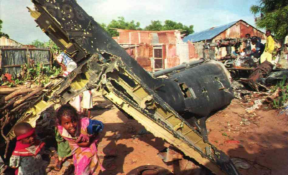 Children play in what is left of a US helicopter shot down during the Battle of Mogadishu in Somalia in 1993. US soldiers went into the city to capture high profile targets, only to have the city militia cut them off and a battle ensue. 2 helicopters were shot down, 19 US soldiers were killed, 2 coalition forces members were also killed, with another 82 total wounded. On the Somali side, anywhere from 300-500 were killed, and anywhere from 500-1000 were wounded. The excellent film Black Hawk Down (2001) depicts this battle.